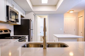 Stunning new kitchens with custom cabinetry and gleaming white granite countertops in select renovated homes! *